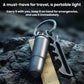 Mini metallic flashlight with key ring and attached keys on textured rock surface