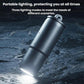 Mini metallic flashlight with key ring shining a bright beam on the ground