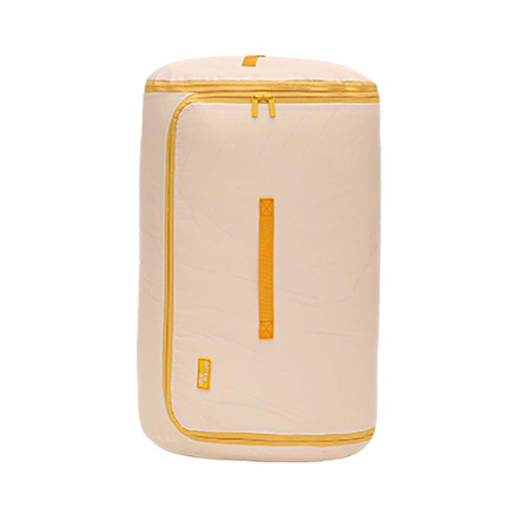 Compressible cylindrical quilt storage bag, milk yellow with vertical zipper detail