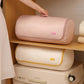 Pink compressible quilt storage bag rolled and ready for compression on a shelf