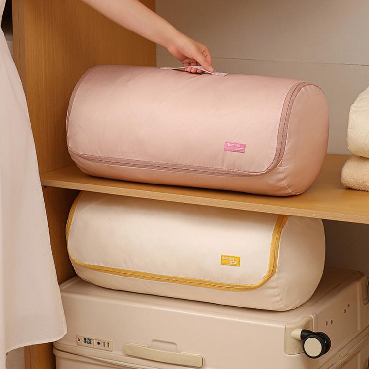 Pink compressible quilt storage bag rolled and ready for compression on a shelf