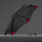 Three-fold manual sun umbrella, black canopy with red accents and curved frame ribs