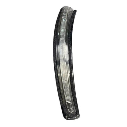 Car side turn signal light with clear lens and black housing, front view