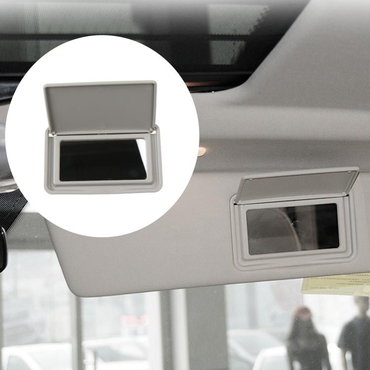 Gray sun visor vanity mirror on car visor with open lid and black window