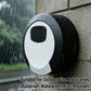 Outdoor black-and-white circular 4-digit key lock box with raindrops on it.