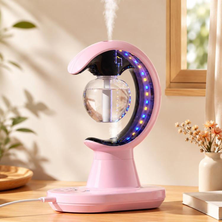 Pink desktop cool-mist humidifier with circular blue LED ring and mist stream