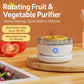 White rotating fruit and vegetable purifier with clear lid and yellow plate on wood base