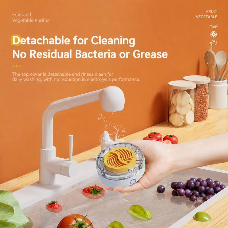 White food purifier with clear lid and yellow plate, held above a produce washing tray