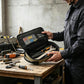 Open black tool storage bag with molded slots and zippered inner compartments
