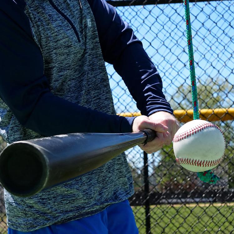 Baseball hitting trainer foam-sleeve baseball attached to black tether rope
