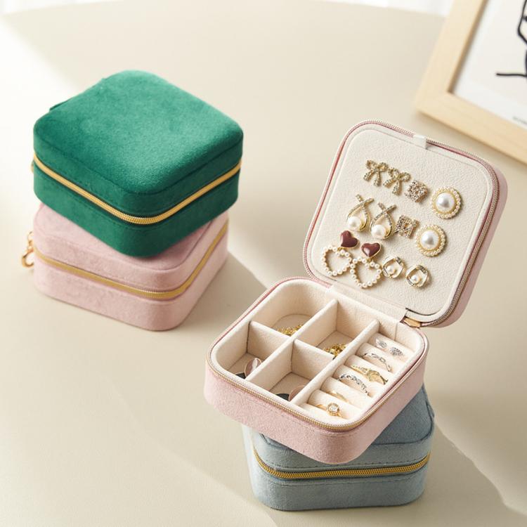 Mini velvet travel jewelry box in pink, open with dividers and earring storage slots