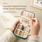 Mini velvet travel jewelry box held open with stud panel, ring slots, and hooks