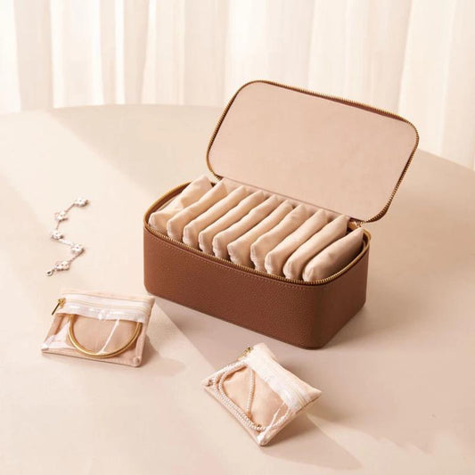 Brown PU jewelry organizer case with open lid and 12 clear zip pouches inside
