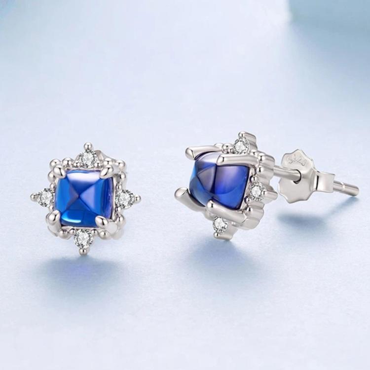 Sterling silver stud earrings, side view, square blue stone with clear halo
