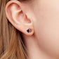 Sterling silver stud earrings with square blue stone and clear halo on ear