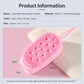 Pink dual-sided bath scrubber with oval silicone bristle side and sponge backing, lanyard loop.