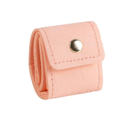 Pink mini jewelry pouch with snap button, folded roll design for rings and earrings.