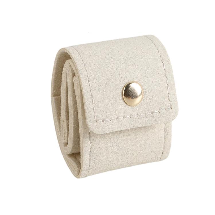 Beige mini jewelry pouch with snap button, folded roll design for rings and earrings.