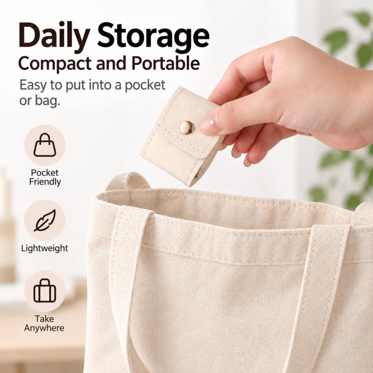 Cream mini jewelry pouch with snap button held near an open fabric storage bag.