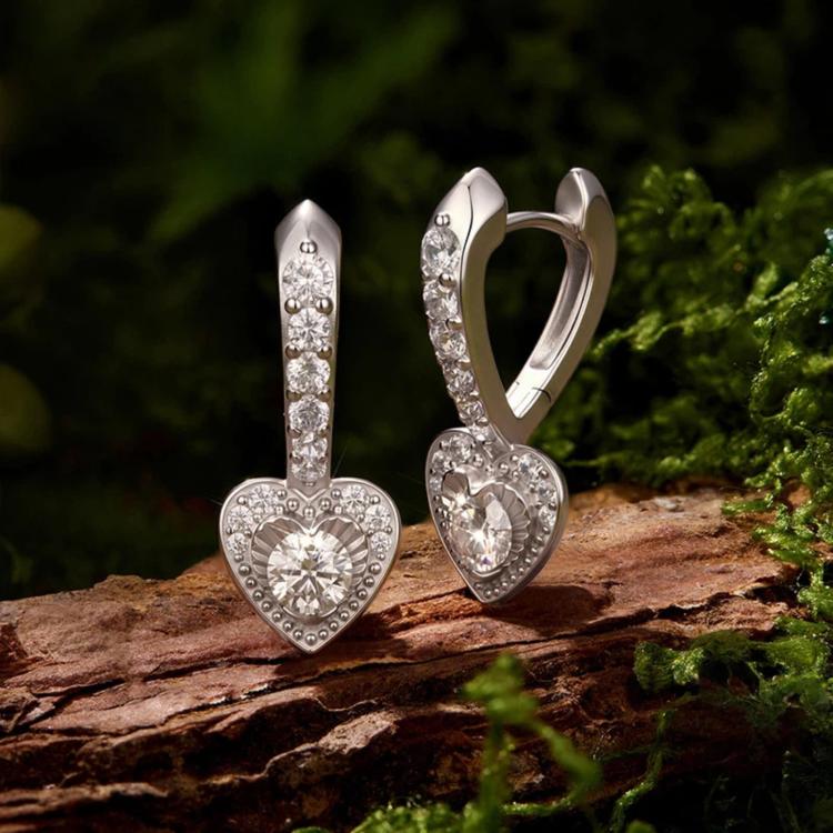Sterling silver heart-shaped hoop earrings with dangling heart and clear stones
