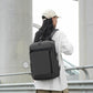 Dark gray laptop backpack with front zip pocket, side profile, adjustable shoulder straps