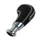 Black gear shift knob with perforated grip, contrast stitched seams, shiny chrome base