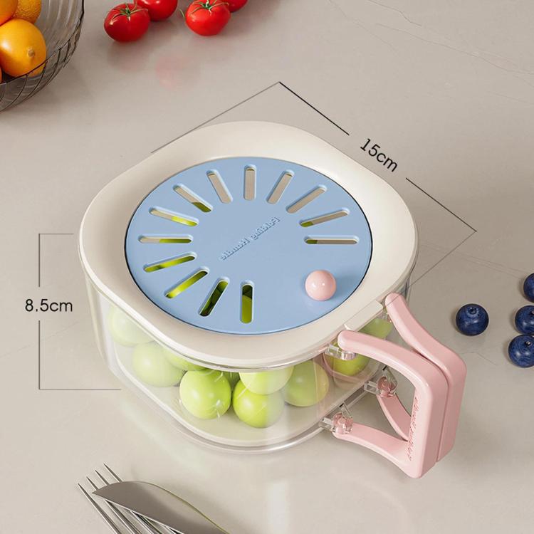 Blue vented lid collapsible fruit colander with pink side handle and light contents