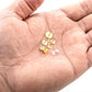 Earring post and back pieces on palm, gold butterfly backs and stud posts