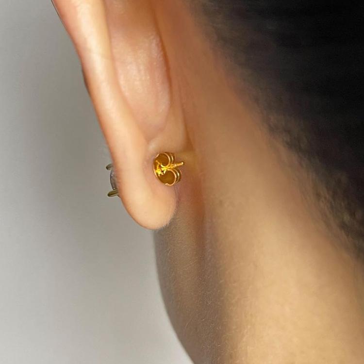 Small gold hoop earring on ear