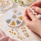 Earring back kit with assorted gold and silver backs and silicone earnuts in tray