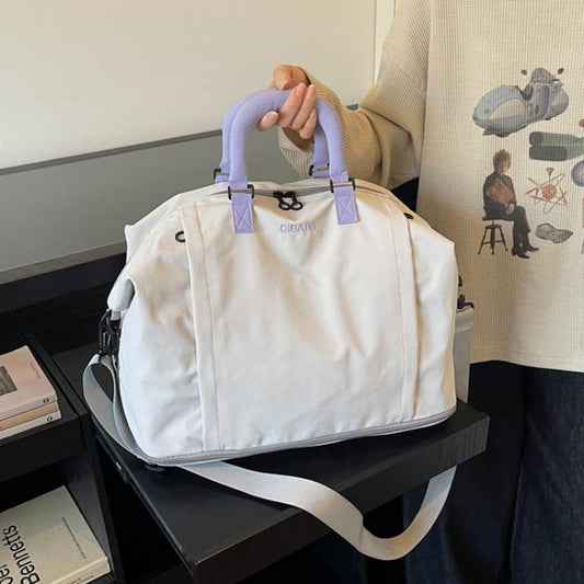 Expandable travel duffel bag in light cream with lavender handles and side straps