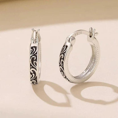 Silver-tone hoop earrings with vintage scroll pattern and hinged clasp posts