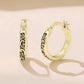 Gold-tone hoop earrings with vintage scroll pattern and hinged clasp posts