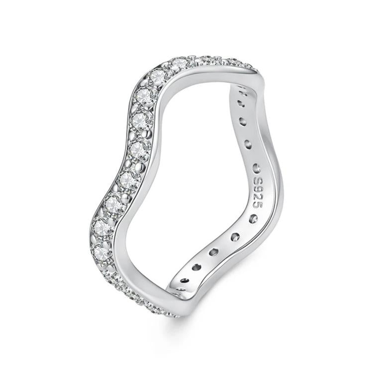 Wave-shaped silver ring with small prong-set moissanite stones along the raised band