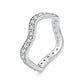 Front view of a wave-style moissanite ring in polished sterling silver with halo stones