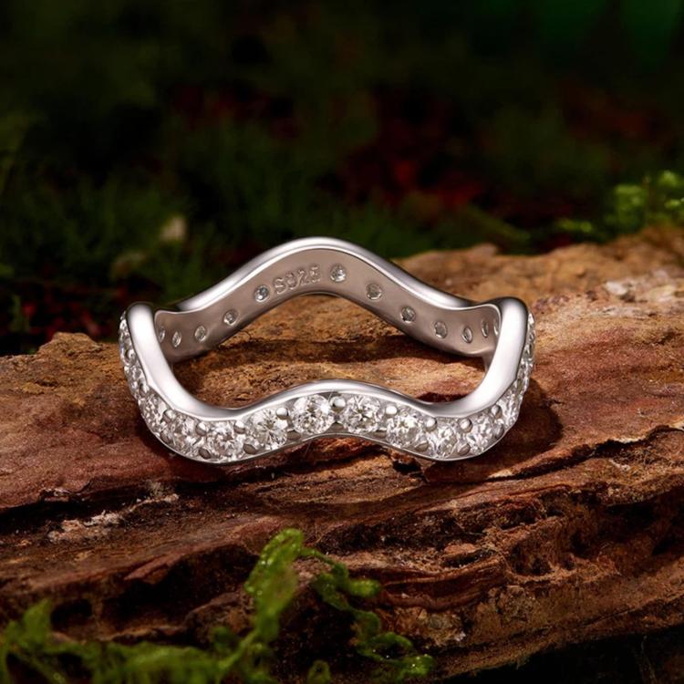 Wave moissanite ring showing inside stamp and rows of sparkling stones on sterling silver