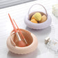 Two silicone makeup brush cleaning bowls holding brushes and sponges, one beige one purple