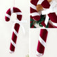 Velvet candy cane ornament with red-and-white stripes and white ribbon bow, hanging loop