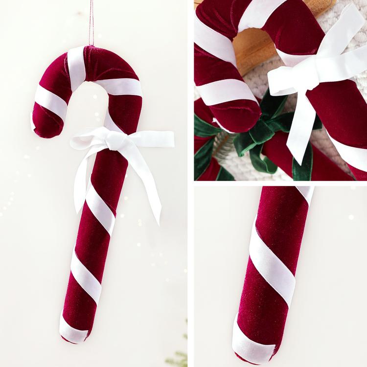 Velvet candy cane ornament with red-and-white stripes and white ribbon bow, hanging loop