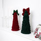 Set of two tiered fabric Christmas tree ornaments on display, dark red and dark green