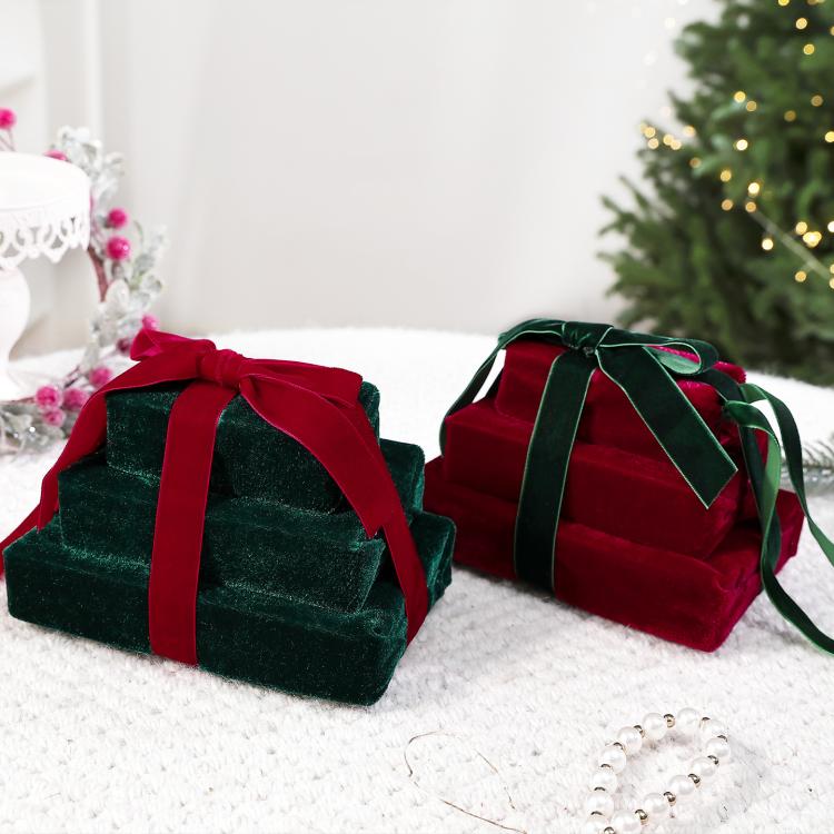 Two velvet gift box ornaments: dark green box with wine red ribbon, and wine red with green.