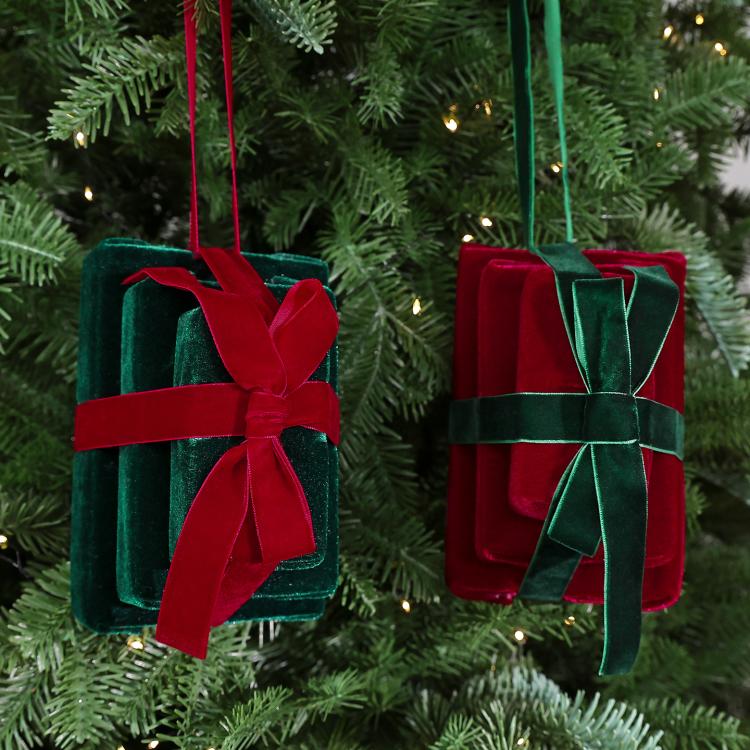 Two velvet gift box hanging ornaments on a Christmas tree: dark green/red and wine red/green.