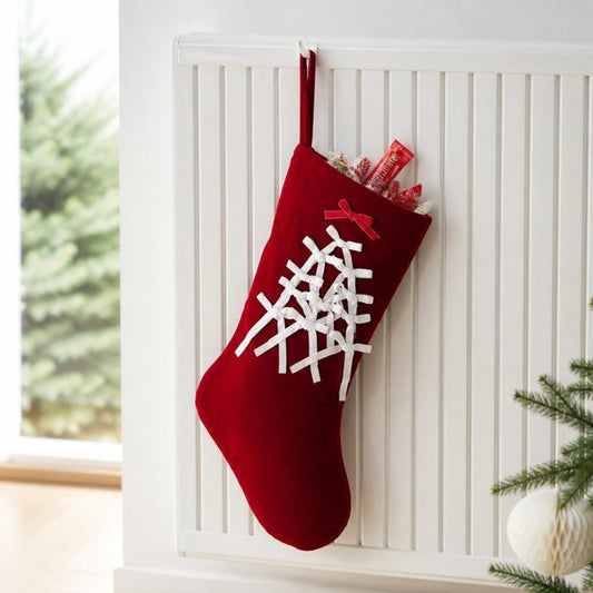 Large velvet Christmas stocking, red with white snowflake-like lacing and hanging loop