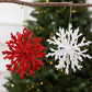 Red and white glitter snowflake ornaments with hanging strings for the tree