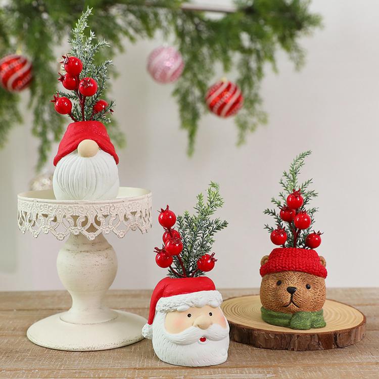 Three Christmas gnome ornaments on display: Santa, snowman, and bear with red berries