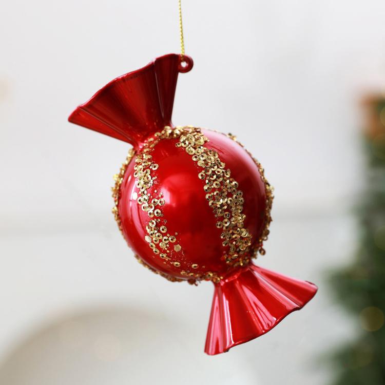 Red candy-shaped Christmas ornament with gold beaded glitter trim and hanging loop