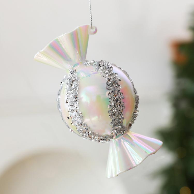 Iridescent white candy-shaped Christmas ornament with silver glitter trim and hanging loop