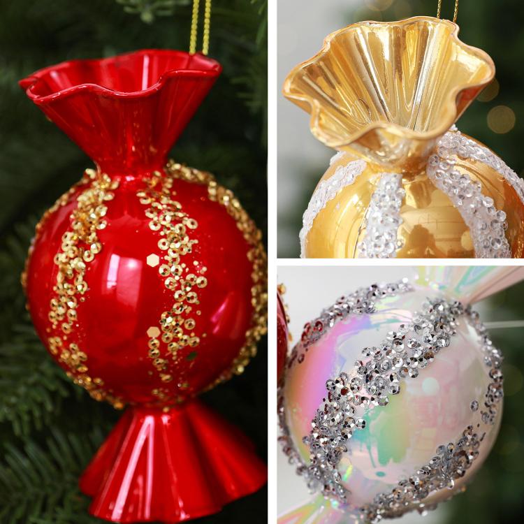 Close-up candy-shaped Christmas ornaments in red and gold with jeweled glitter trim