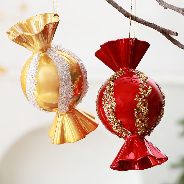 Hanging red and gold candy-shaped Christmas ornaments with jeweled glitter trim