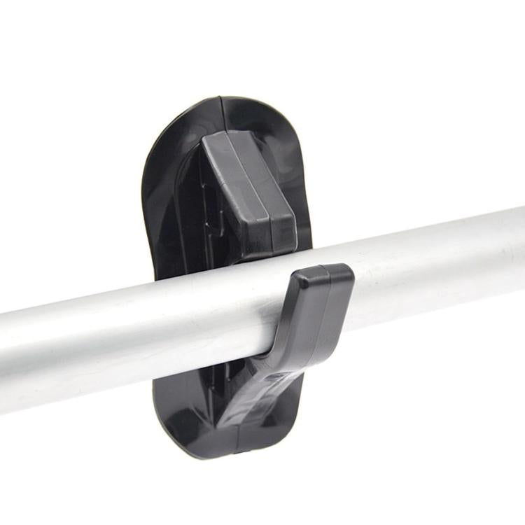 Black paddle holder clamp with U-shaped end on white inflatable tube.